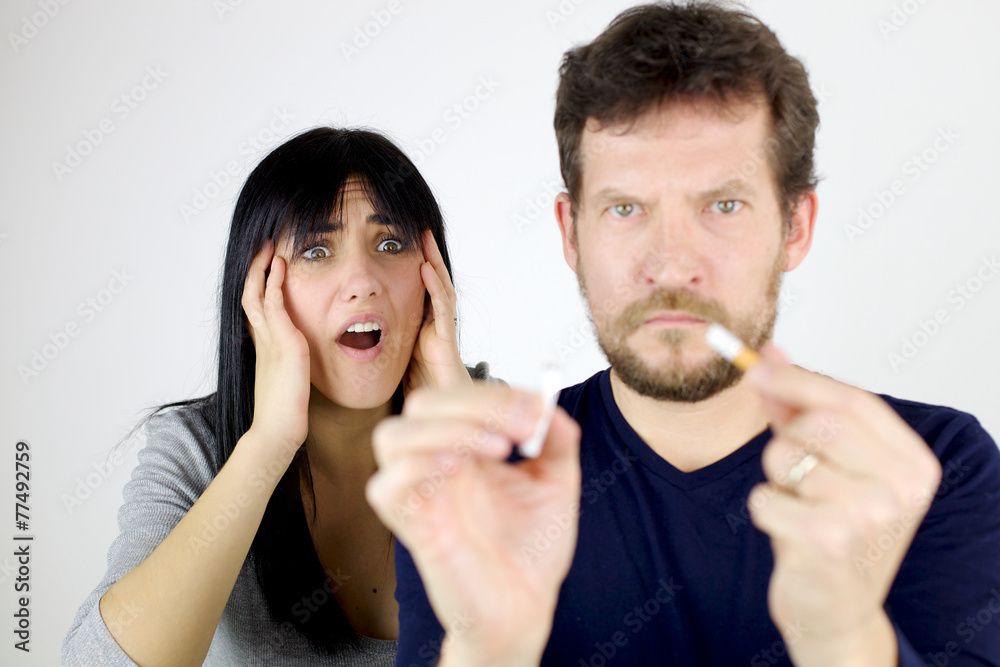Woman desperate about man breaking cigarette Woman desperate about man breaking cigarette