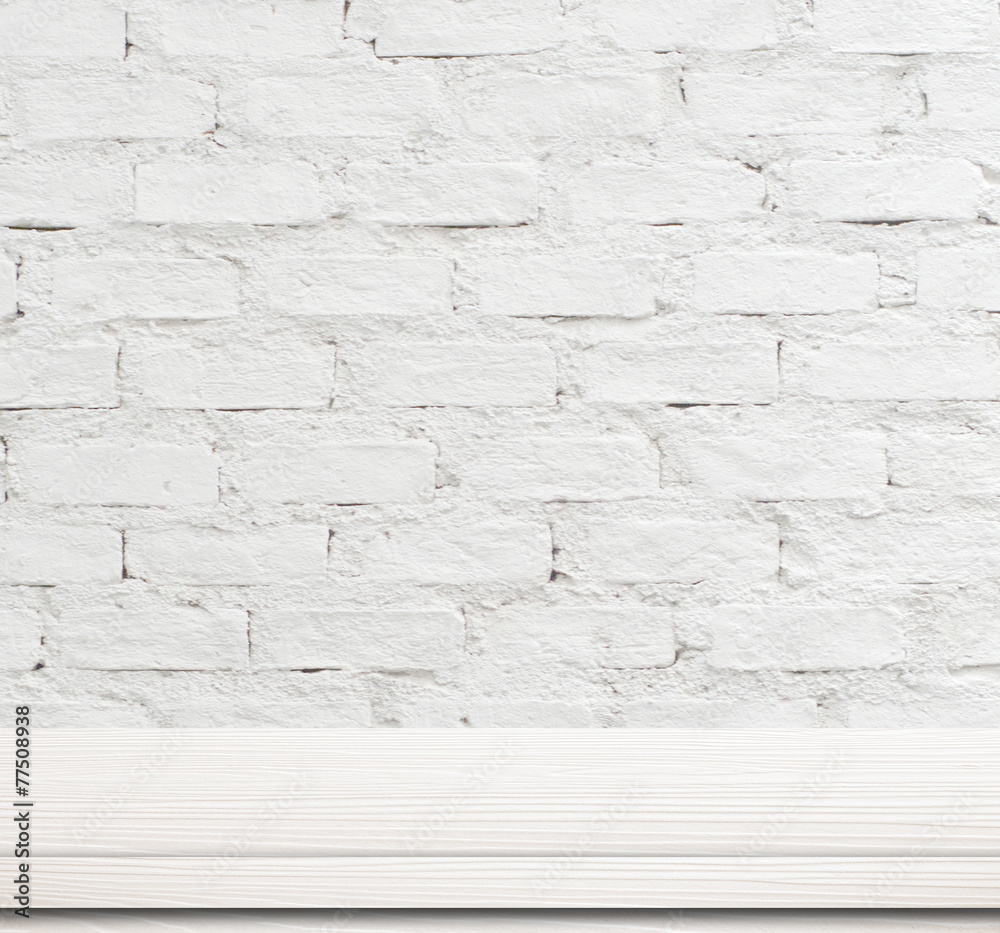 Empty white wooden table over brick wall. Empty white wooden table over brick wall.