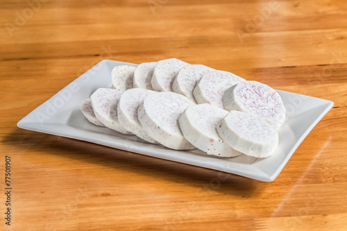 Taro slice on rectangle dish over the wooden table