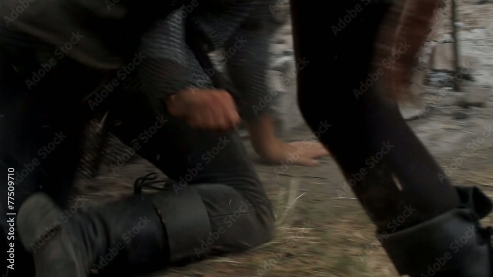 Men gets kicked in the stomach and rolls on the floor Men gets kicked in the stomach and rolls on the floor