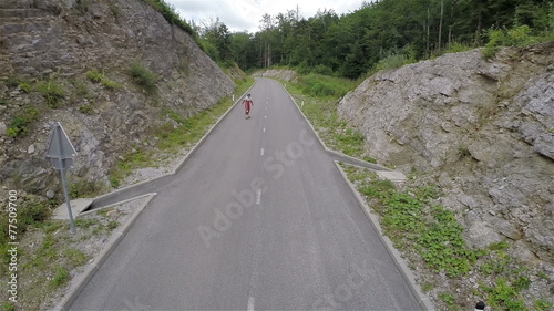 Two longboard skaters riding under camera in slow motion photo