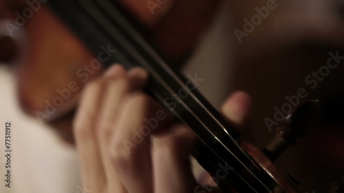 Close up pan shot of a violin player