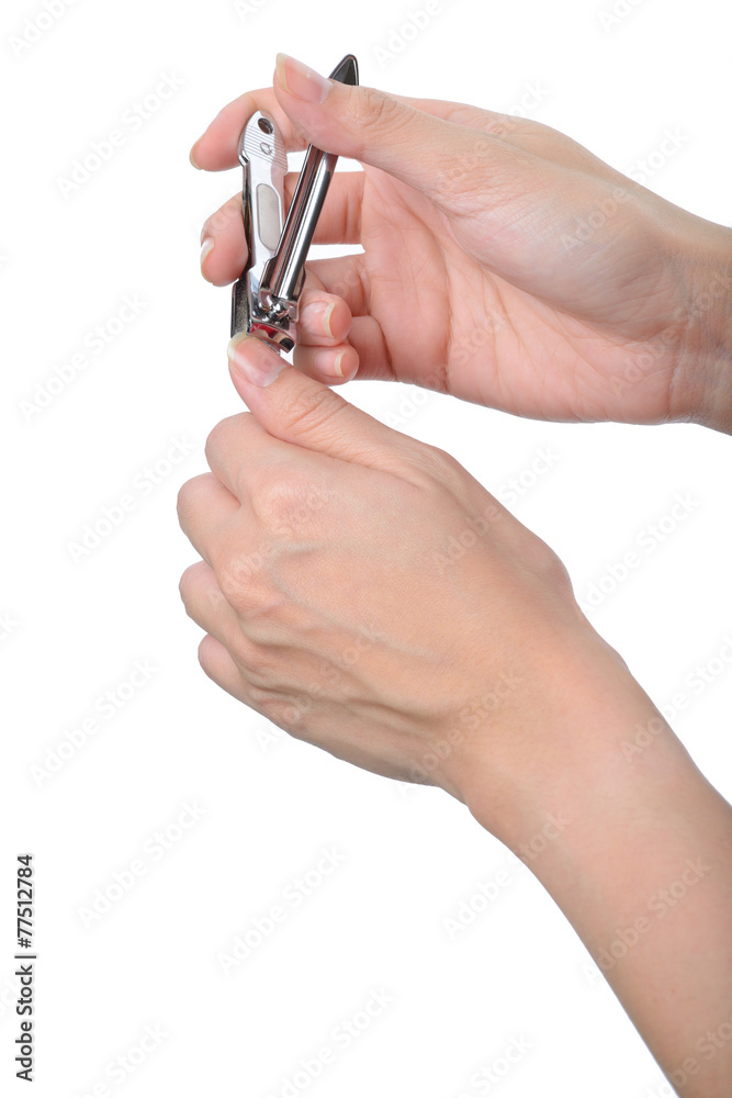 woman hand manicure with nail clipper isolated on white woman hand manicure with nail clipper isolated on white