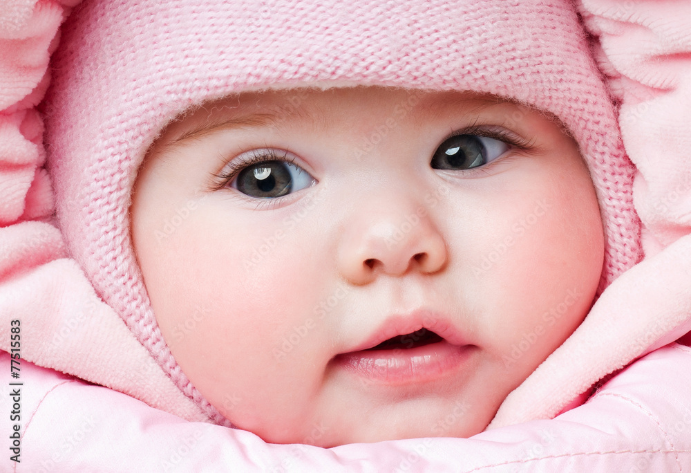 Beautiful baby in a pink hat. Winter season Beautiful baby in a pink hat. Winter season