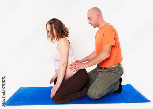 The husband massaging pregnant wife back