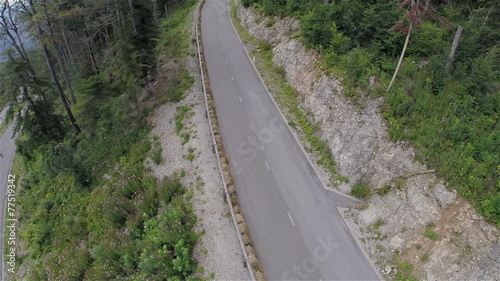 Big group of longboard riders speeding down the road aerial photo