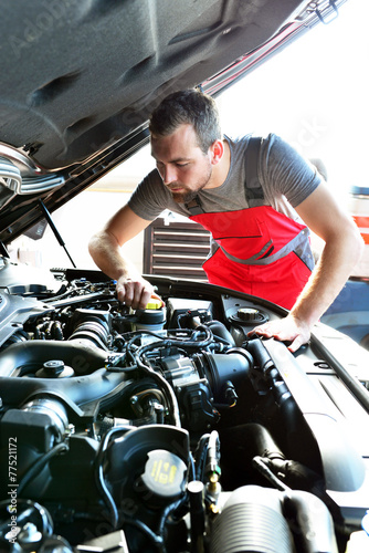 Automechaniker // professional mechanic repairs engine of car