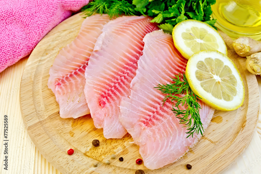 Tilapia with oil and lemon on light board Tilapia with oil and lemon on light board