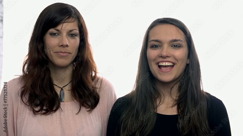 Two women talking in camera on white background Two women talking in camera on white background