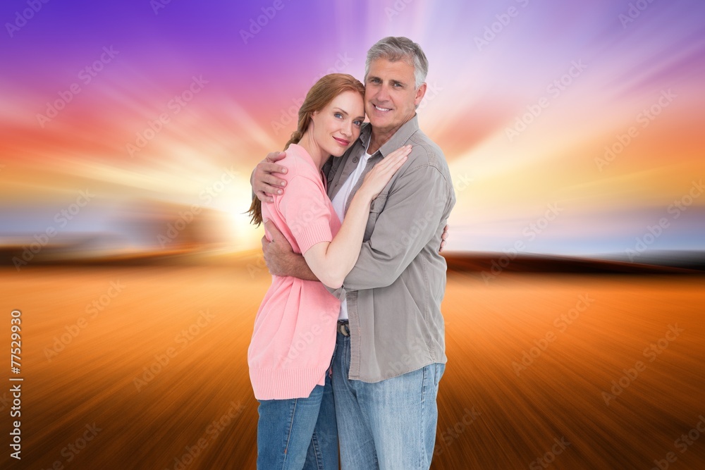 Composite image of casual couple hugging and smiling Composite image of casual couple hugging and smiling