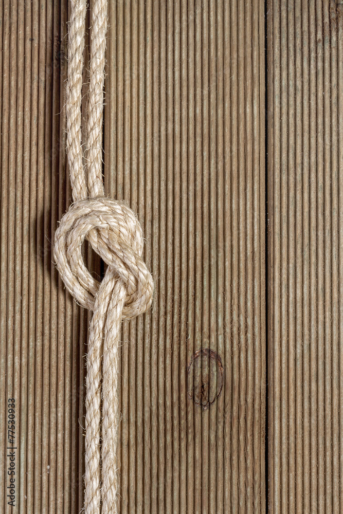 Wooden background with rough rope