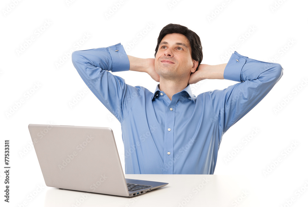 Smiling man looking up while working at laptop computer Smiling man looking up while working at laptop computer