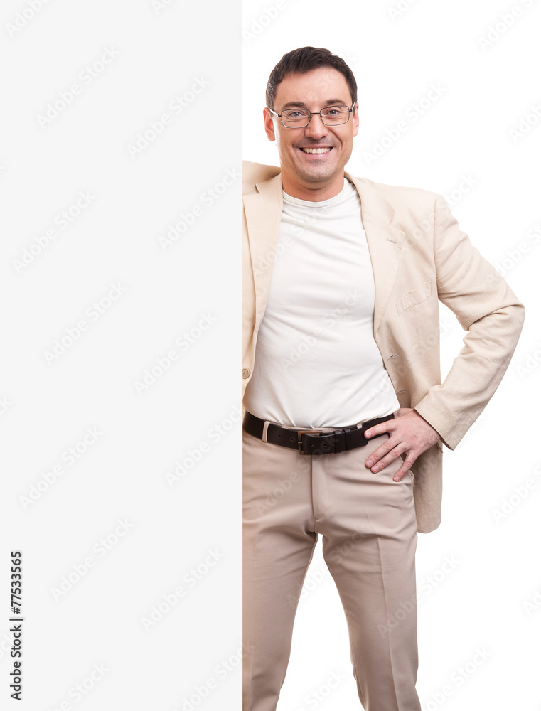 Fototapeta premium Cheerful young handsome man with blank signboard