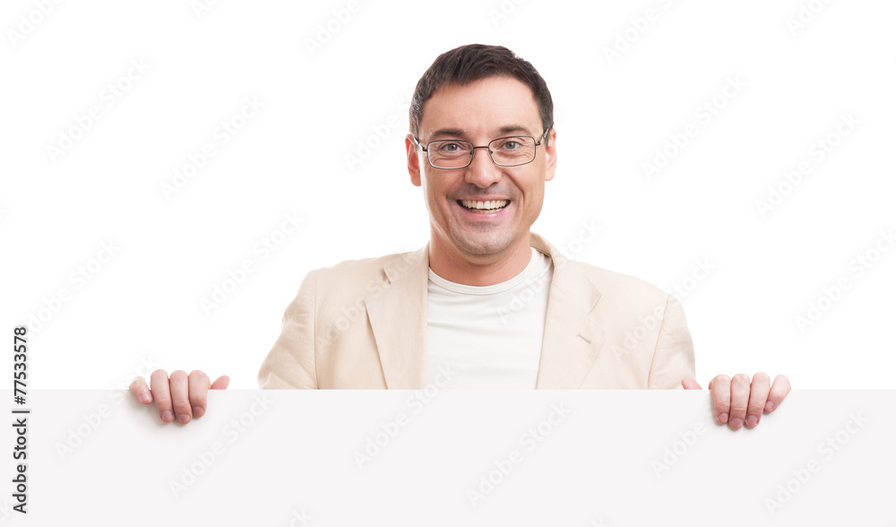 Cheerful young handsome man with blank signboard Cheerful young handsome man with blank signboard