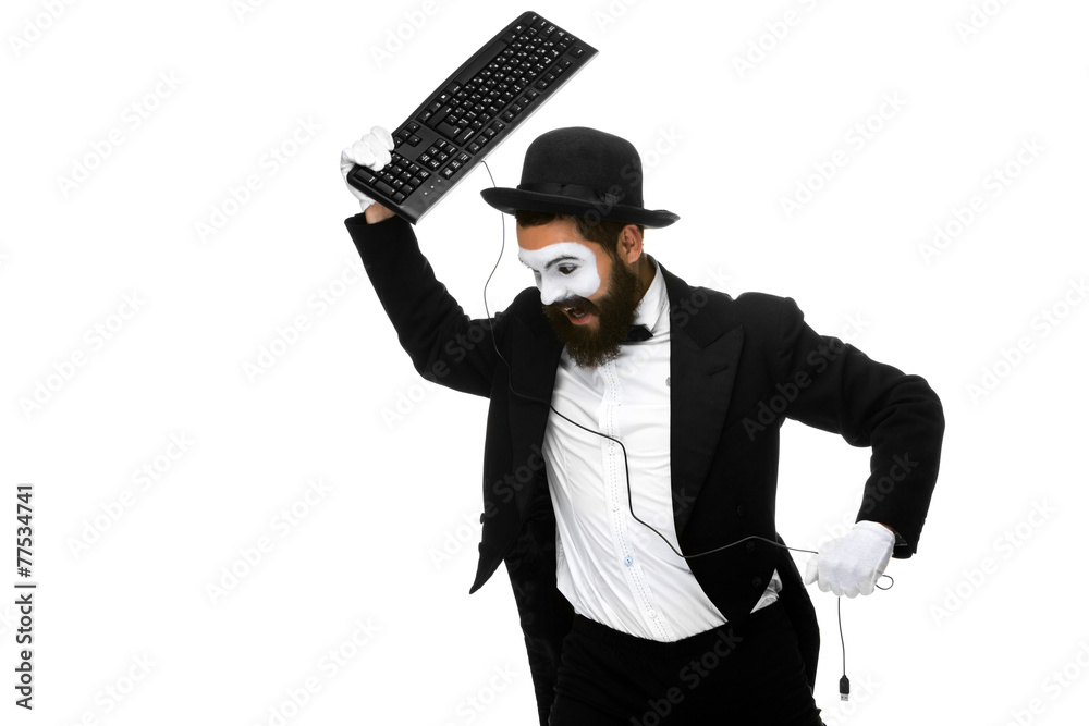 Angry mime as a businessman is destroying keyboard Angry mime as a businessman is destroying keyboard