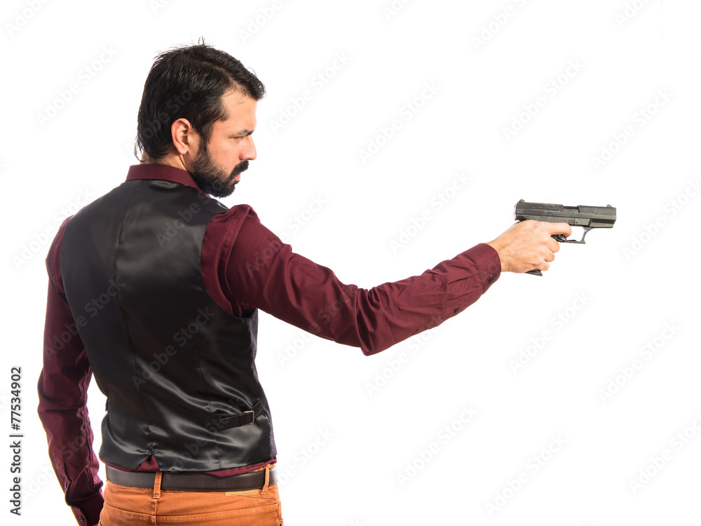 Man wearing waistcoat shooting with a pistol Man wearing waistcoat shooting with a pistol