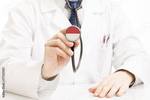 Obraz na płótnie Doctor holding stethoscope with flag series - Monaco w salonie