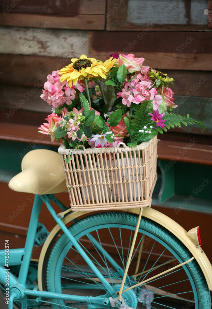 Vintage bicycle has beautiful colorful flowers in a basket