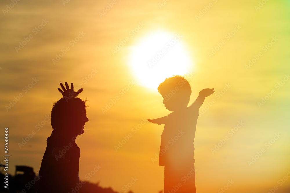 father and son having fun at sunset