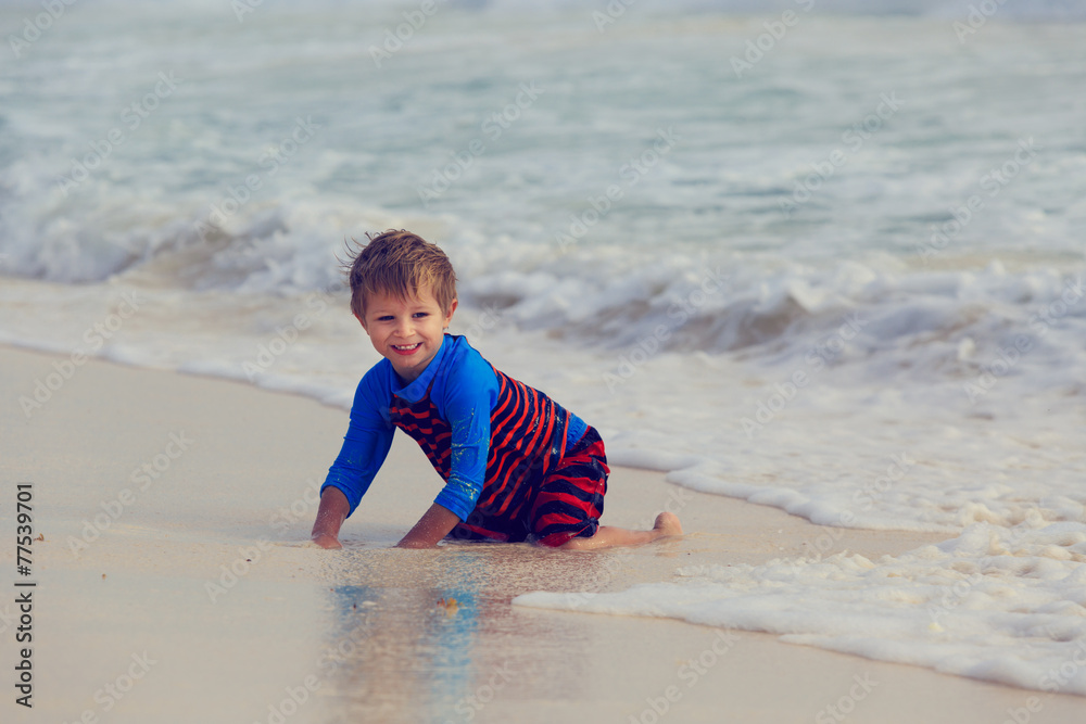 little boy playing with waves on sand beach little boy playing with waves on sand beach