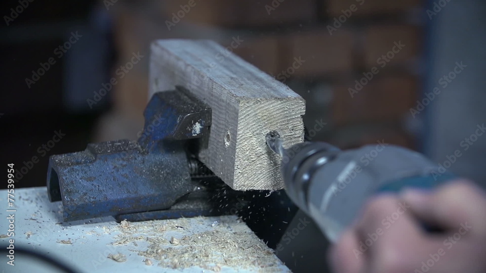 Using electric drill to make a hole in a piece of wood Using electric drill to make a hole in a piece of wood