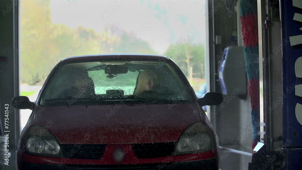 Front shot of car being sprayed with shampoo Front shot of car being sprayed with shampoo