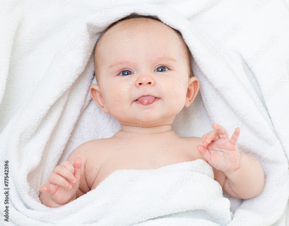 Cute funny baby in bathing towel showing tongue Cute funny baby in bathing towel showing tongue