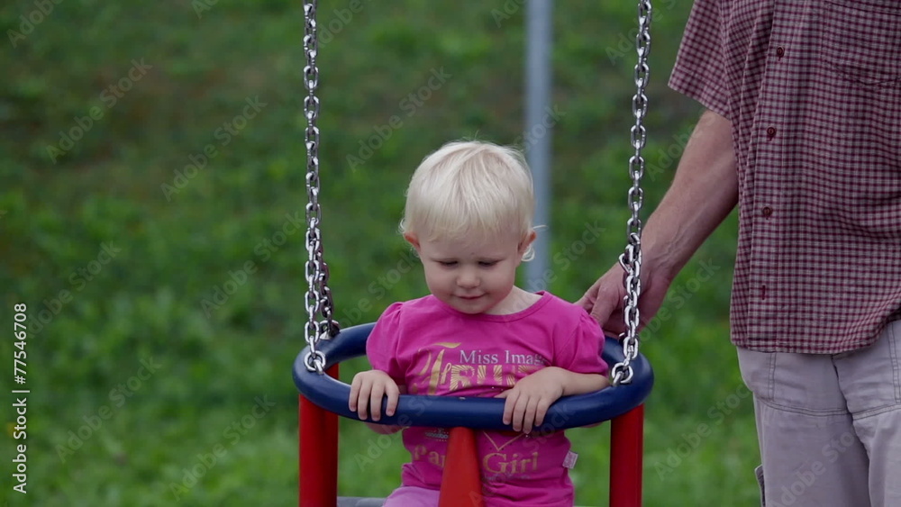 Grandfather swings little girl Grandfather swings little girl