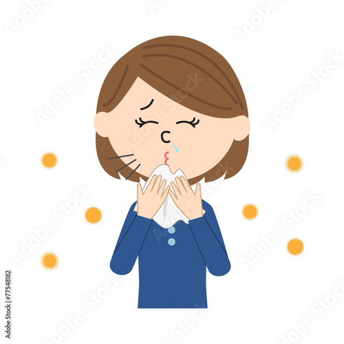 A young woman sneezing, allergen flowing in the air