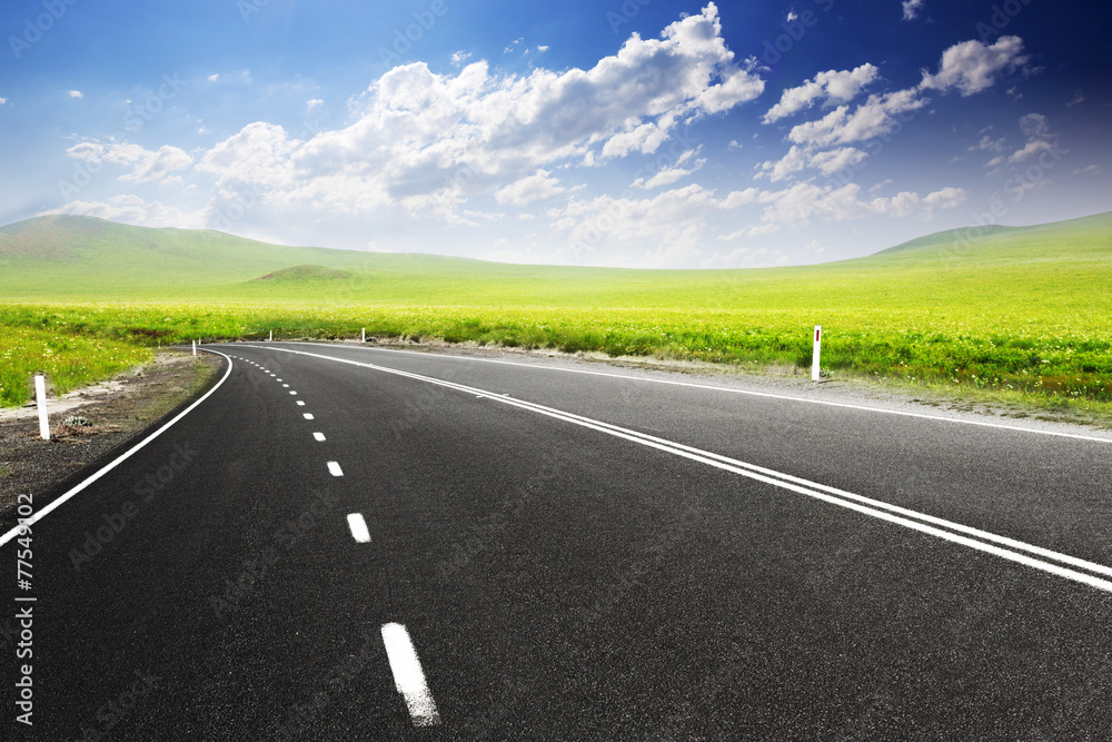 Road through meadow with cloud and sky background