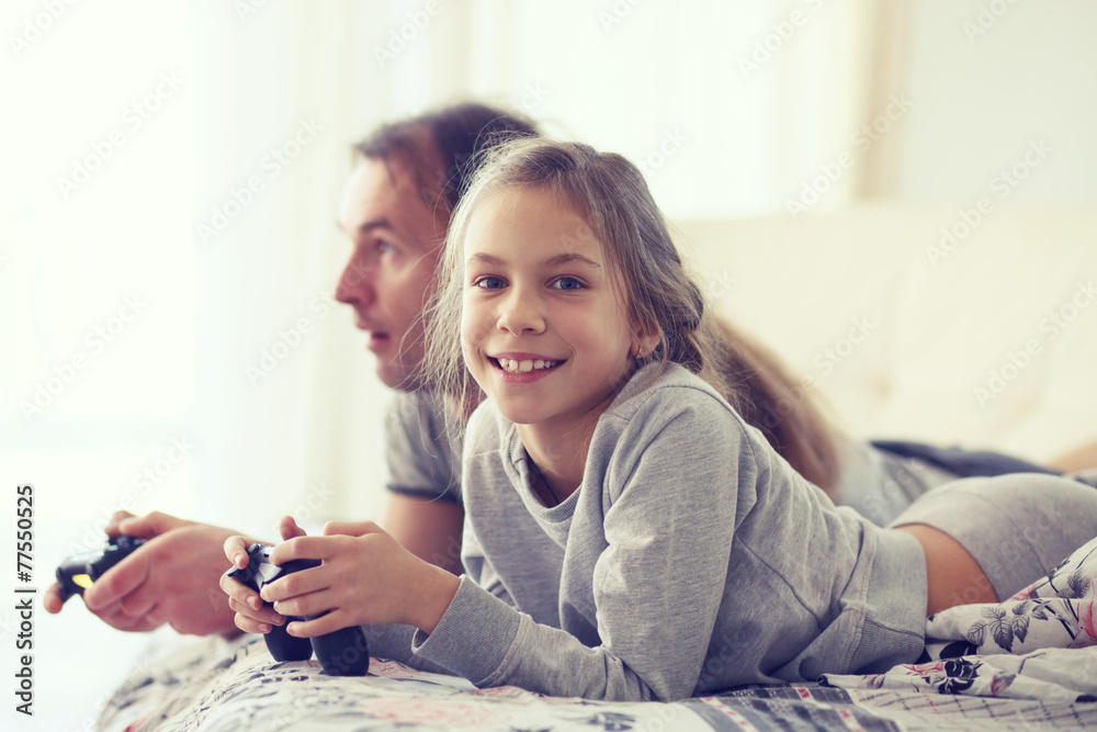 Child playing video game with father Child playing video game with father