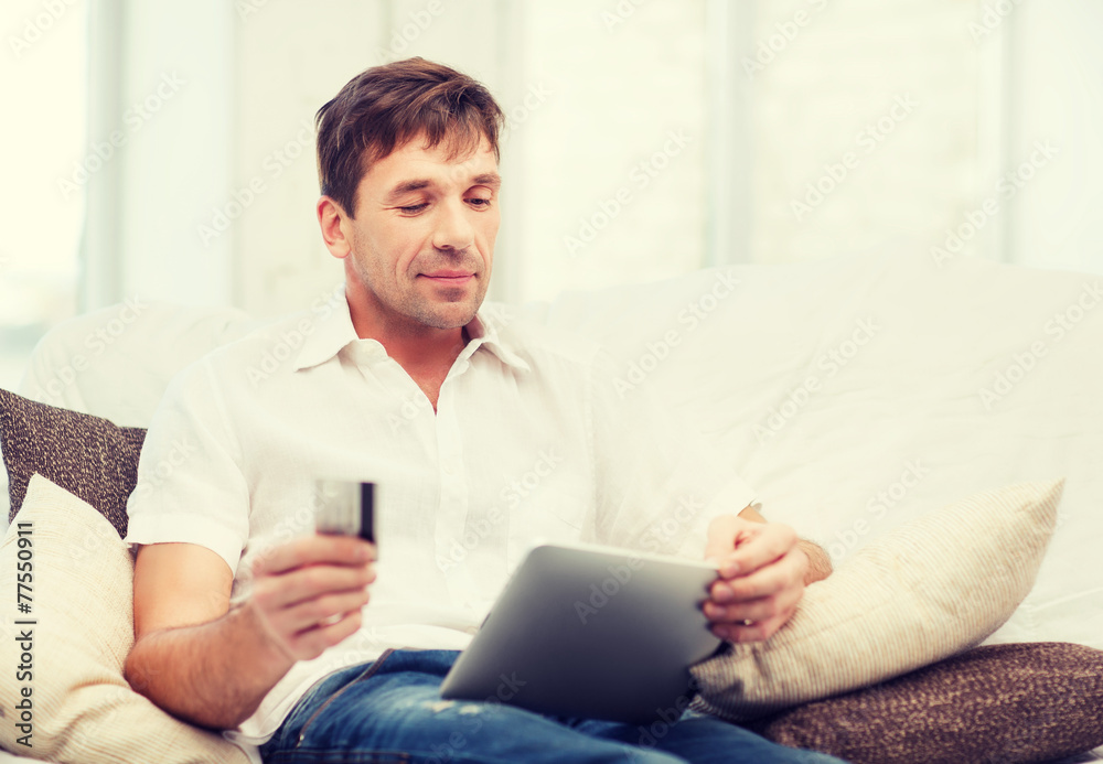 man with tablet pc and credit card at home man with tablet pc and credit card at home