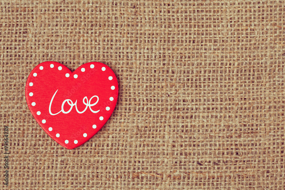 Red valentine's day heart on retro textile background with vinta Red valentine's day heart on retro textile background with vinta