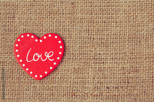 Red valentine's day heart on retro textile background with vinta