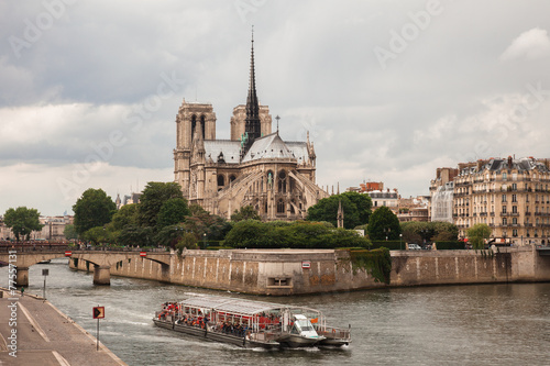Notre Dame with tourist boat on Seine in Paris