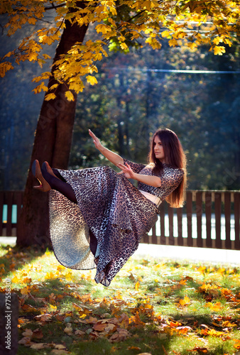  levitating girl in a leopard print dress