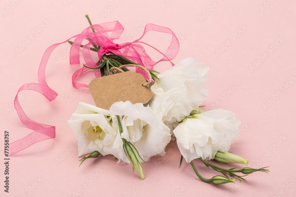 white flowers on pink with an empty name tag on white flowers on pink with an empty name tag on