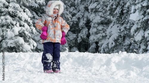 a child while enjoying in the idyllic winter time soroundings photo