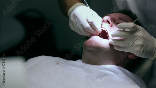 Dentist checking the quality of client's teeth and possible caries