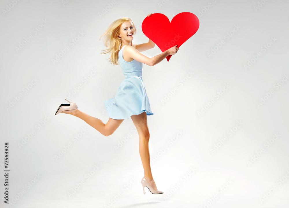 Blond cute lady running with heart Blond cute lady running with heart