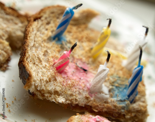 Improvised birthday cake made of candles on a toast. photo