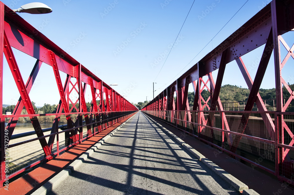 Red painted metal road bridge