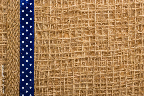 Dotted ribbon on burlap cloth background