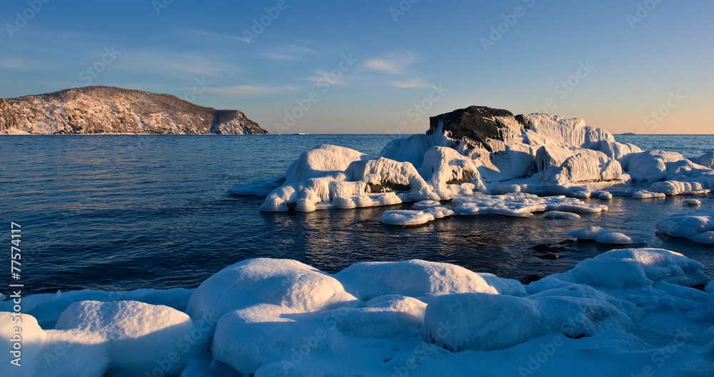 Stones covered with ice on the beach. Stones covered with ice on the beach.