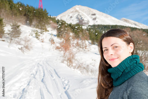 A smiling girl on a snowy trail shows the way, Abruzzo Italy