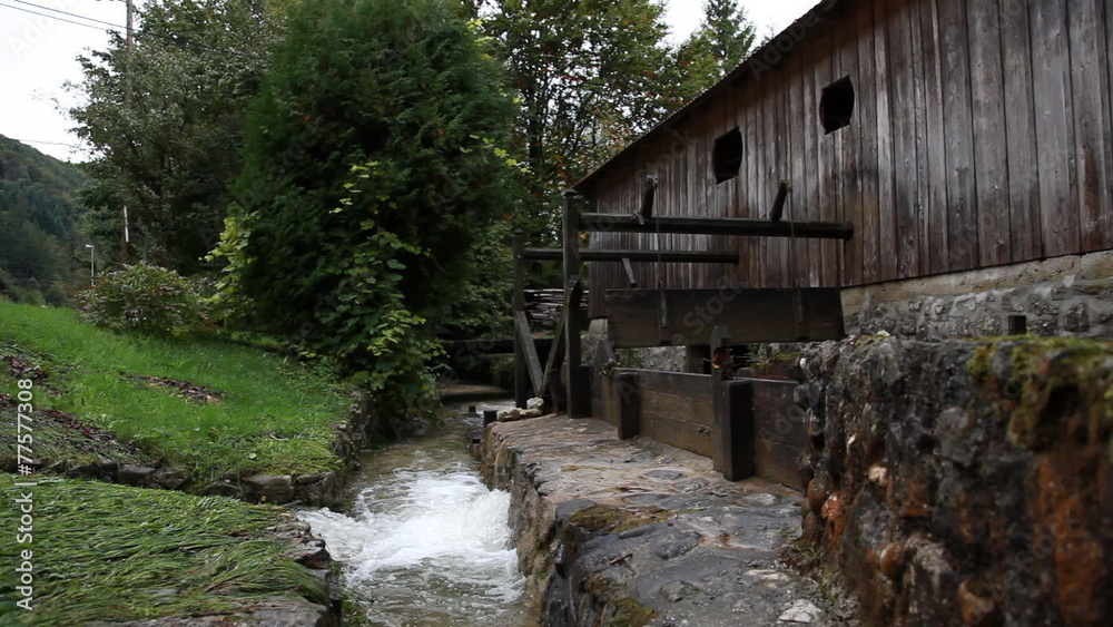 View of a wooden mill on the river View of a wooden mill on the river