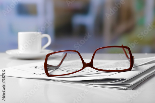 Glasses and newspapers, close-up