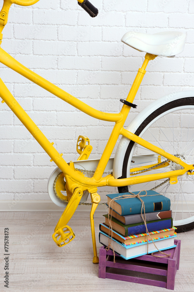 Bicycle with books on brick wall background Bicycle with books on brick wall background