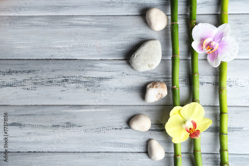Fototapeta Naklejka Na Ścianę i Meble -  Orchid flowers  and bamboo with pile stones on wooden