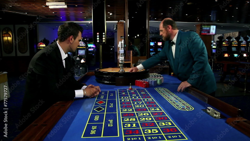 Young and attractive man playing roulette in casino Young and attractive man playing roulette in casino